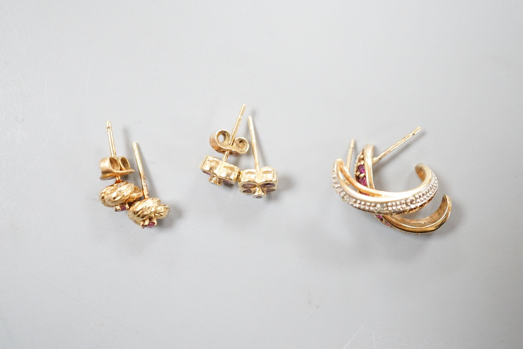 Three assorted modern pairs of 9ct and gem set ear studs